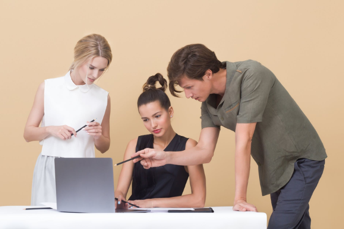 three people looking at the screen